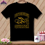 A black t-shirt featuring yellow text that reads Pittsburgh Quilter, with a spool of thread.