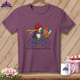 Penguin on a bicycle with fabric rolls, wearing a tomato hat and measuring tape.