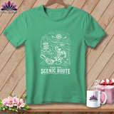 Green t-shirt with a scenic route design featuring signs and a quilt pattern, text 