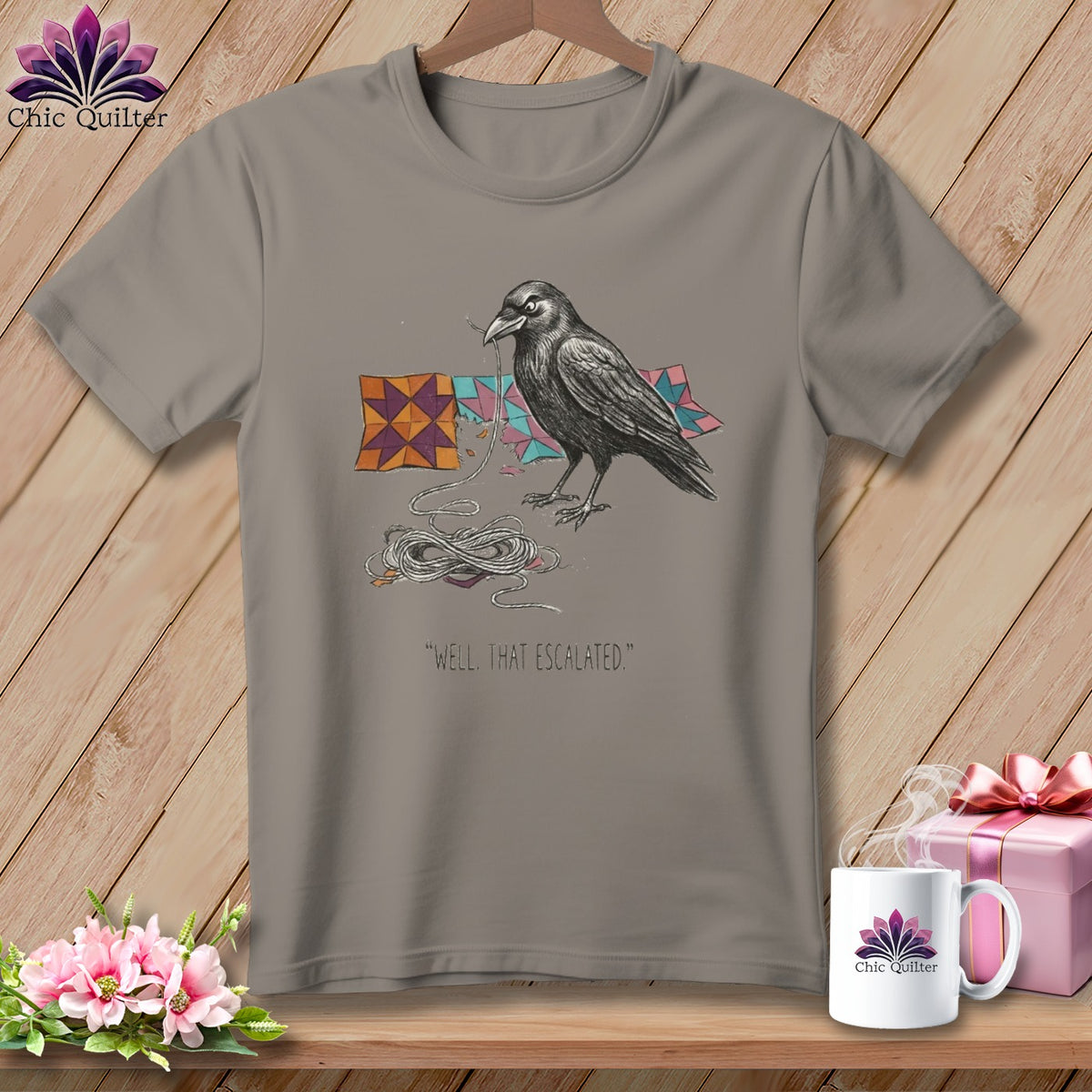 Raven with yarn and quilt pieces on a t-shirt, "Well, that escalated."