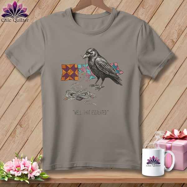 Raven with yarn and quilt pieces on a t-shirt, "Well, that escalated."