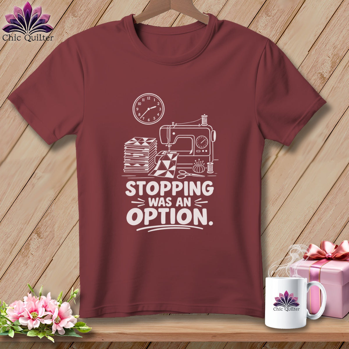 Maroon t-shirt with sewing machine, fabric, and text "STOPPING WAS AN OPTION".