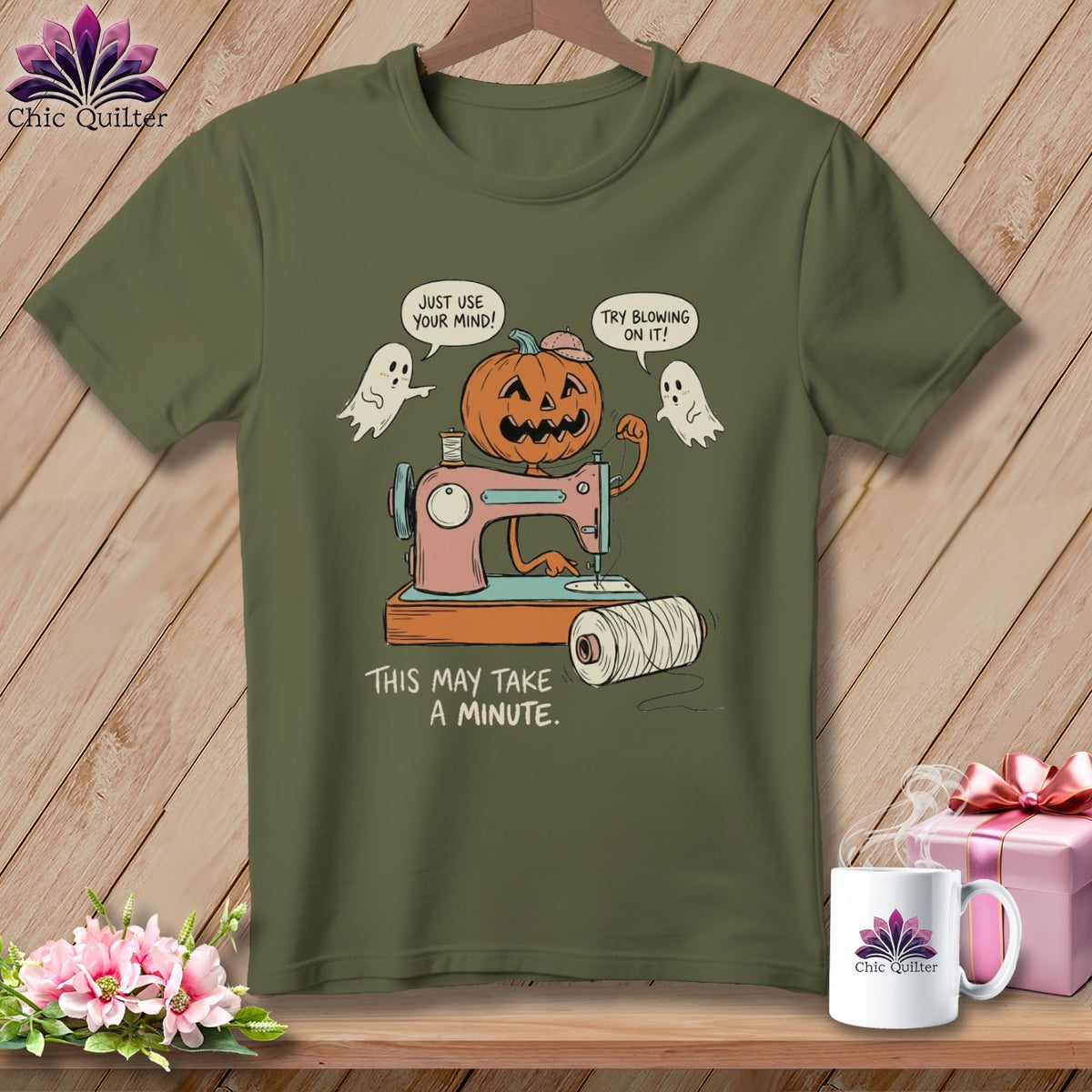 Pumpkin on sewing machine with ghosts and text "This may take a minute."