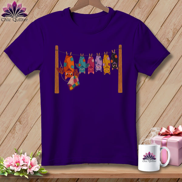 Purple t-shirt with cartoon bats hanging on a clothesline.