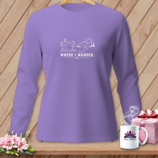Lavender long-sleeve shirt with a white graphic of a sewing machine, mountains, and the text "WHERE I WANDER."