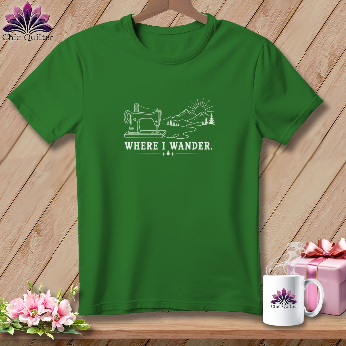 Green t-shirt with sewing machine, mountains, sun, and text "WHERE I WANDER."