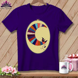 Purple t-shirt with crescent moon quilt design featuring a witch and a sewing spool.