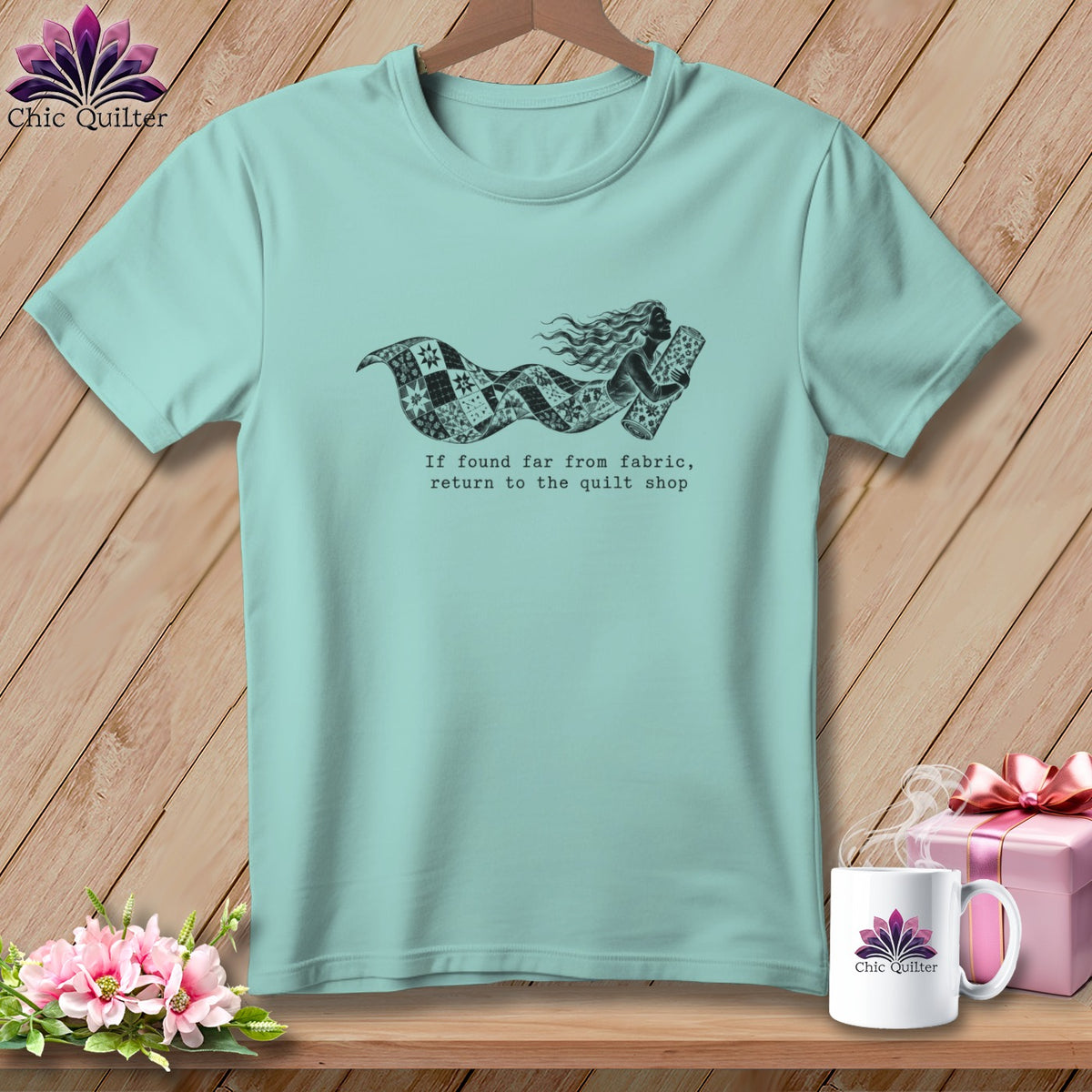 Teal t-shirt with a mermaid made of quilt fabric and the text "If found far from fabric, return to the quilt shop."