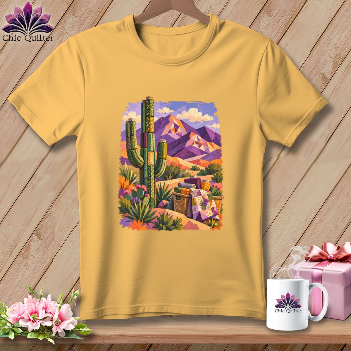 Gold short-sleeve t-shirt featuring a desert landscape graphic with a saguaro cactus, mountains, and a picnic basket.