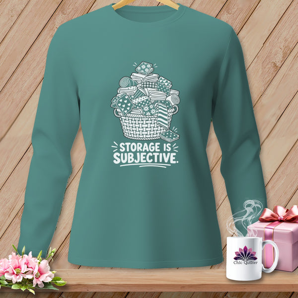 Teal long-sleeve shirt with a basket of fabric and the text "STORAGE IS SUBJECTIVE."