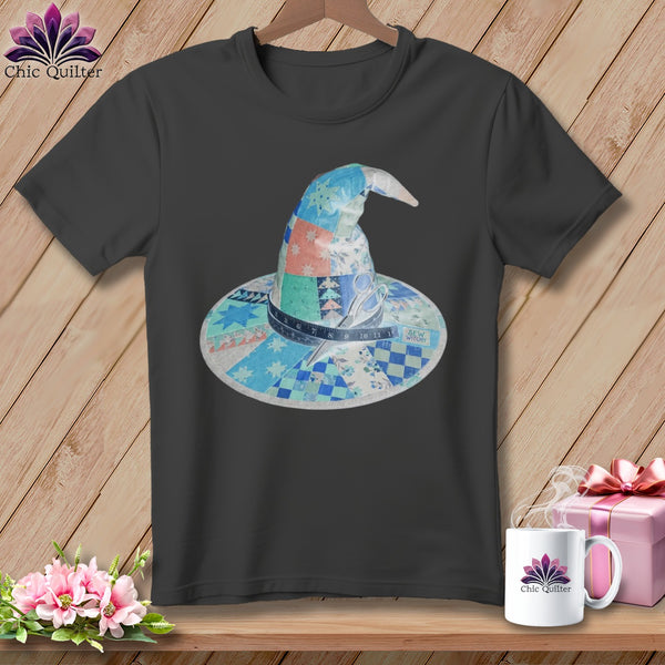 Dark t-shirt with a patchwork witch hat design, scissors, and measuring tape.