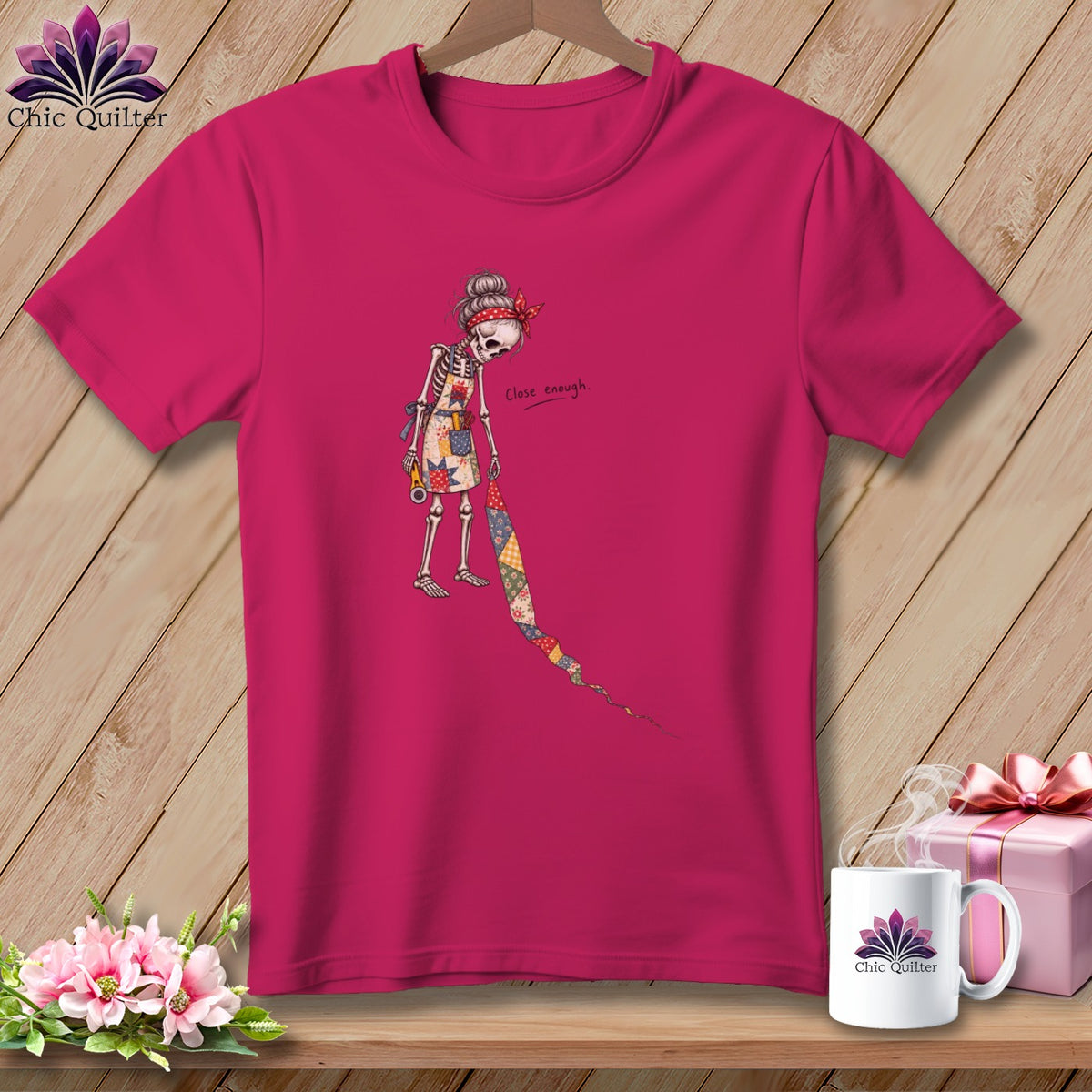 Skeleton quilter graphic with "Close enough" text on a pink t-shirt.