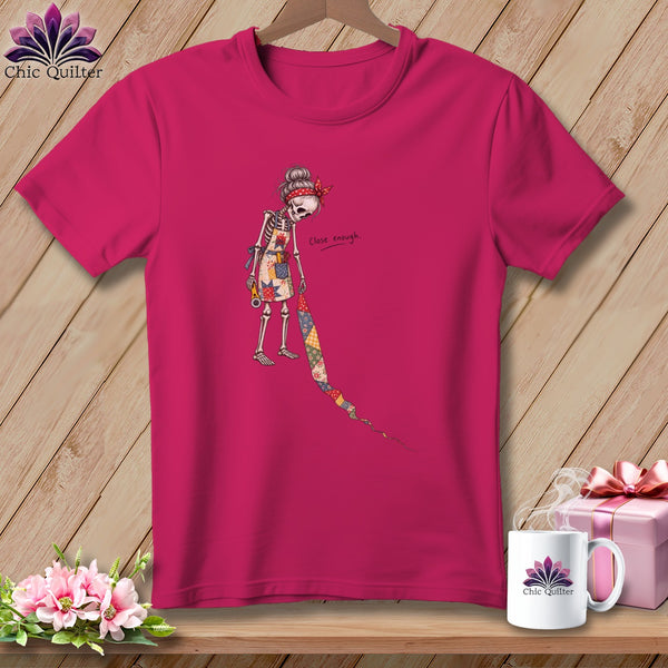 Skeleton quilter graphic with "Close enough" text on a pink t-shirt.