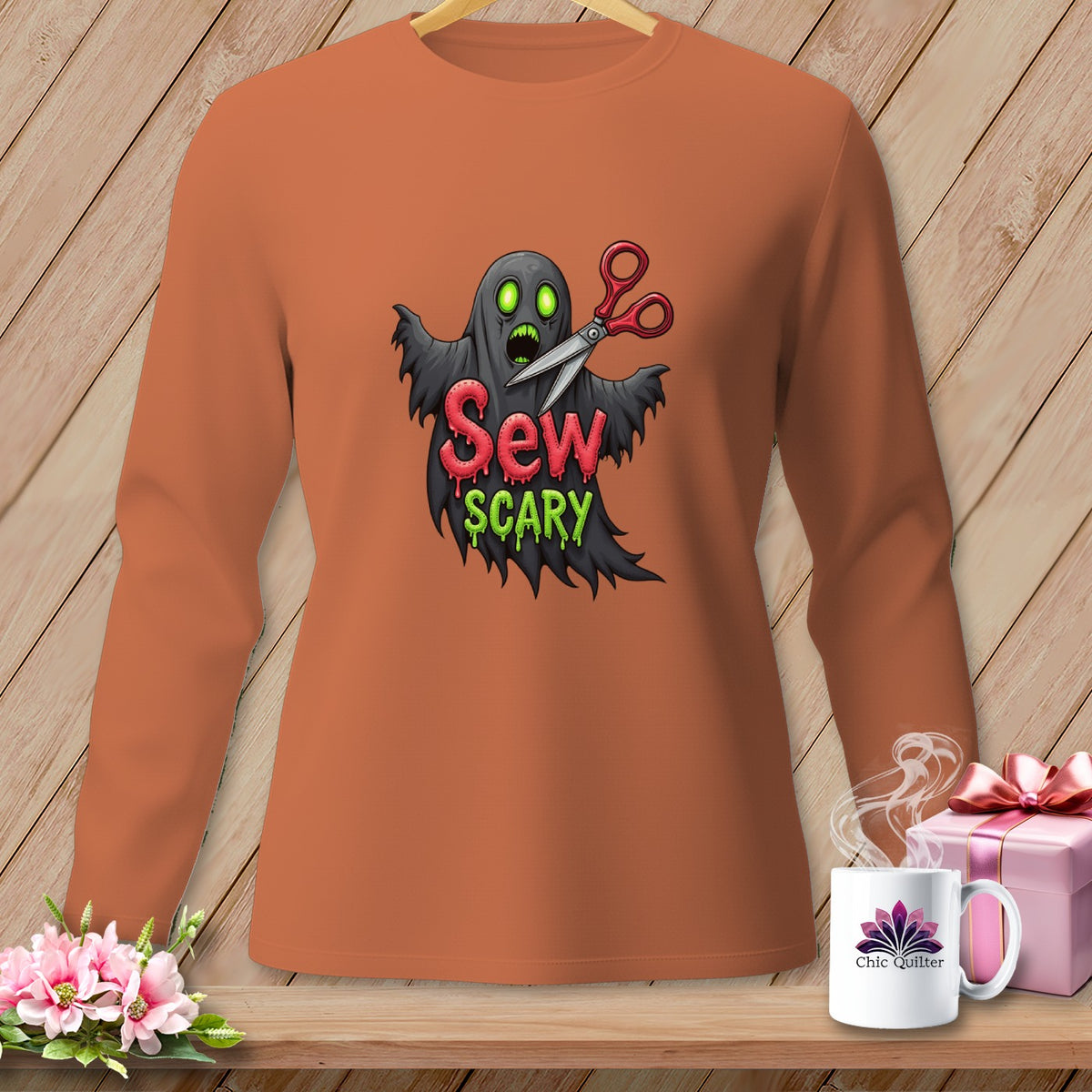Orange long-sleeve shirt with a "Sew Scary" ghost graphic and scissors.