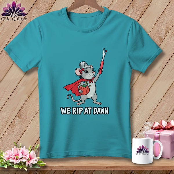 Teal t-shirt featuring a cartoon mouse wearing a cape, thimble hat, and holding a seam ripper with text reading WE RIP AT DAWN.