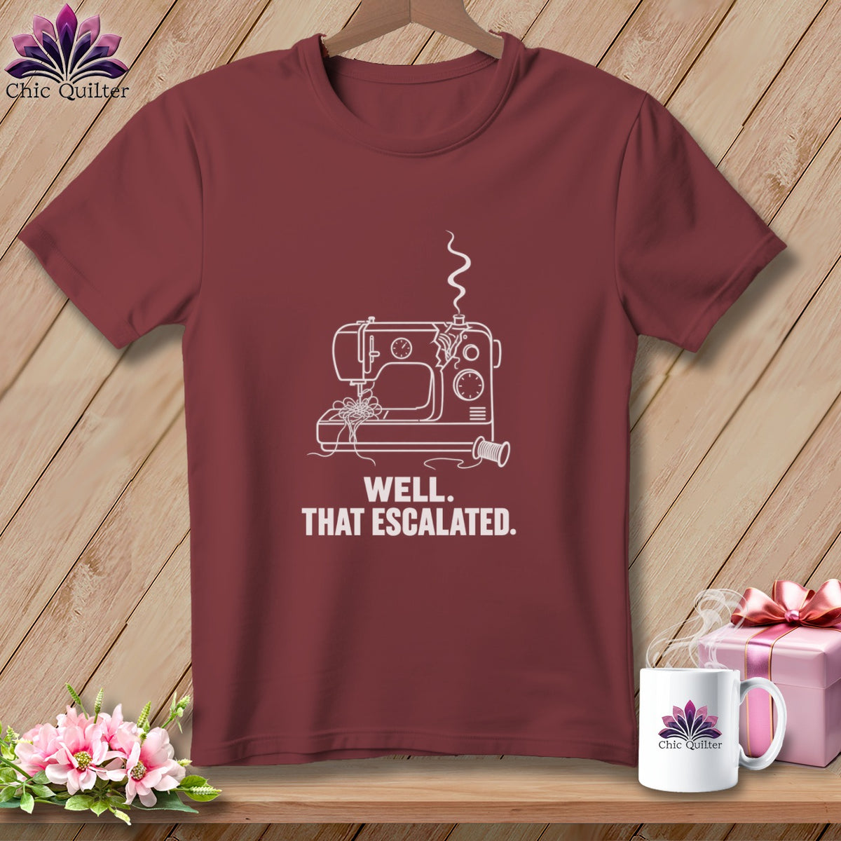 Maroon t-shirt with white line art of a sewing machine and text "WELL. THAT ESCALATED."