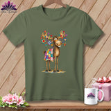 An olive green t-shirt displays an illustration of a cartoon moose wearing a colorful patchwork quilt and hanging decorations on its antlers.