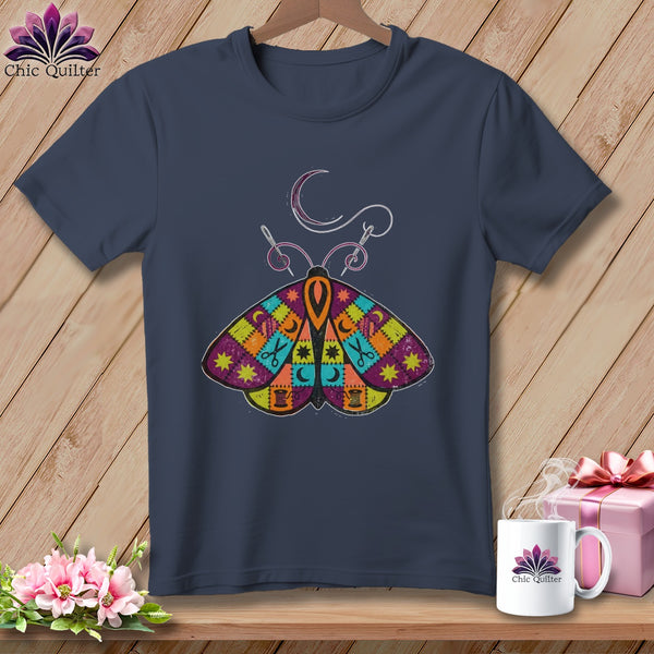 Dark blue t-shirt with colorful patchwork moth and sewing graphic.