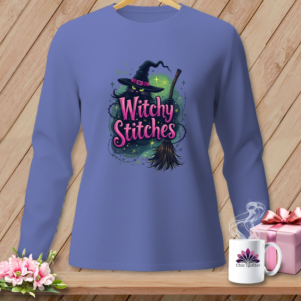 Purple long-sleeve shirt with black cat, witch hat, broom, and "Witchy Stitches" text.