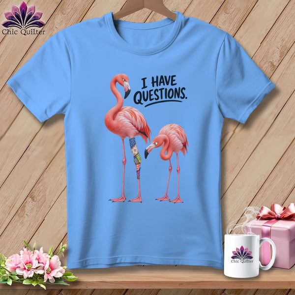 Light blue t-shirt with two flamingos and text "I HAVE QUESTIONS."