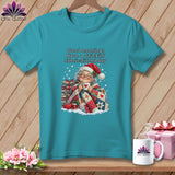 A teal t-shirt featuring an illustration of an elderly woman in a Santa hat, holding a mug and wrapped in a quilt.
