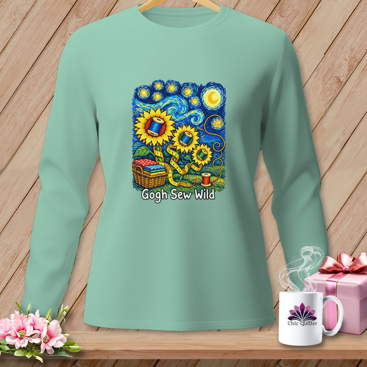 Mint long sleeve shirt with sunflowers, thread spools, measuring tape, and "Gogh Sew Wild" text.