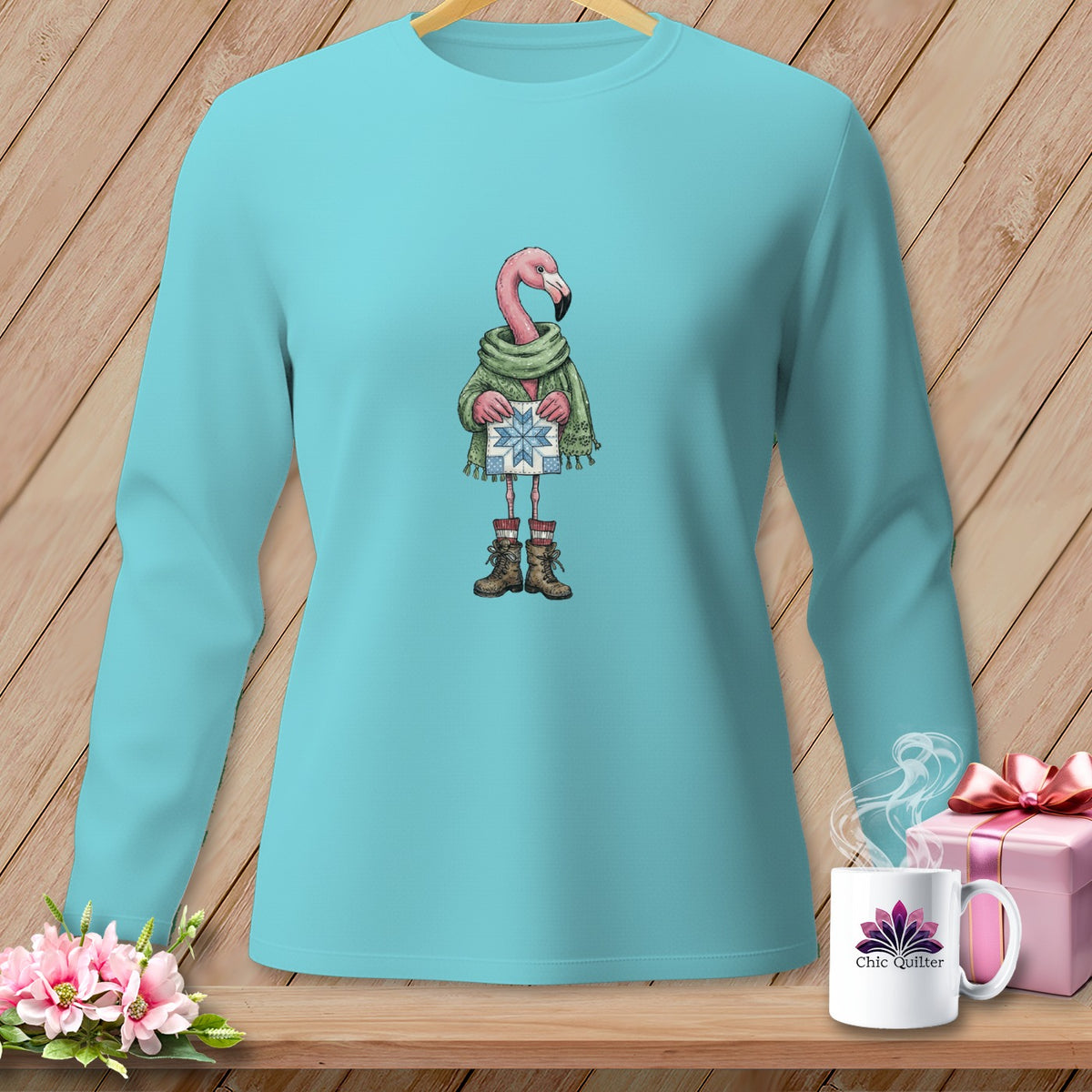 Turquoise long-sleeve shirt with a cartoon flamingo holding a gift.