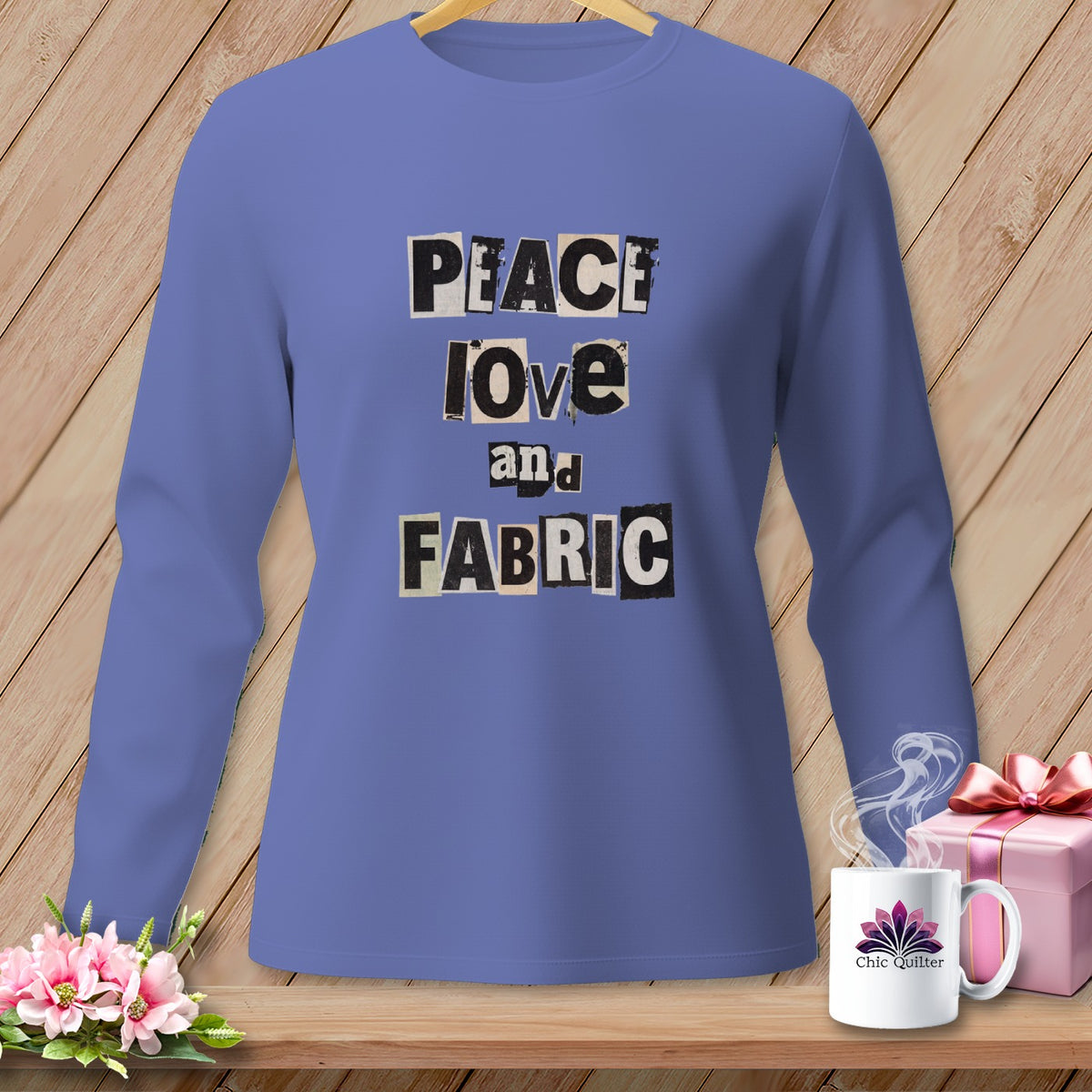 Purple long-sleeve shirt with "Peace, Love and Fabric" text in cut-out letters.