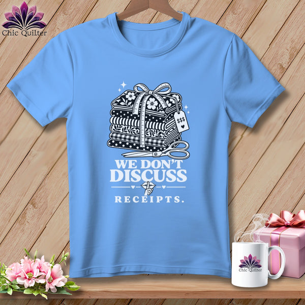 Light blue t-shirt with graphic of stacked fabric, scissors, and text "WE DON'T DISCUSS RECEIPTS."