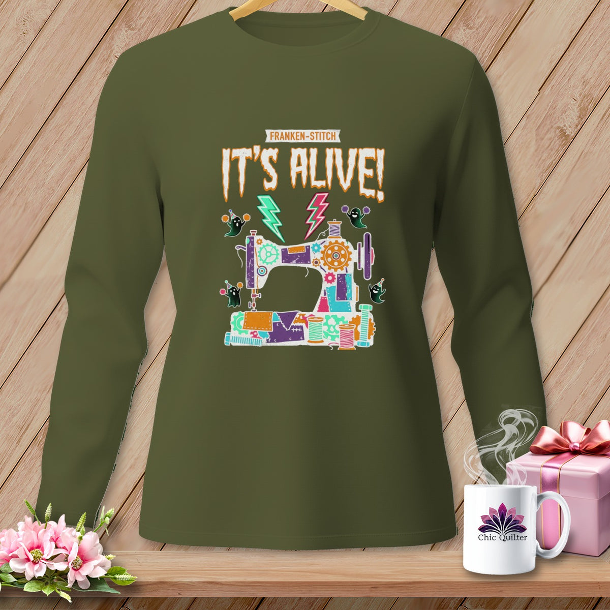 Green long-sleeve shirt with a Frankenstein-stitch sewing machine graphic that says "IT'S ALIVE!"