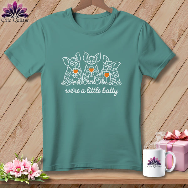 Teal t-shirt with three bats holding wine glasses, text "we're a little batty".