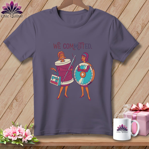 T-shirt graphic of two women, one as a spool of thread, the other with a rotary cutter, with text "WE COMMITTED."