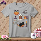 Gray t-shirt with Halloween quilting motifs: pumpkin, ghost spool, cat, and witch hat.