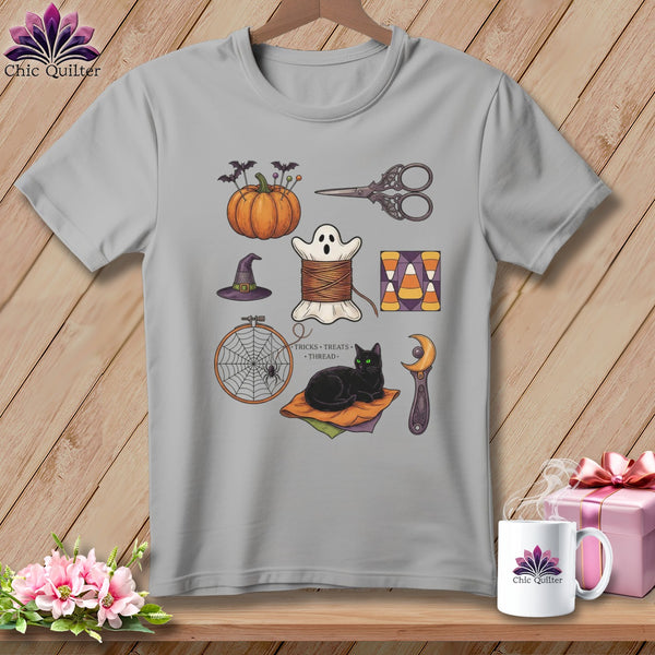 Gray t-shirt with Halloween quilting motifs: pumpkin, ghost spool, cat, and witch hat.