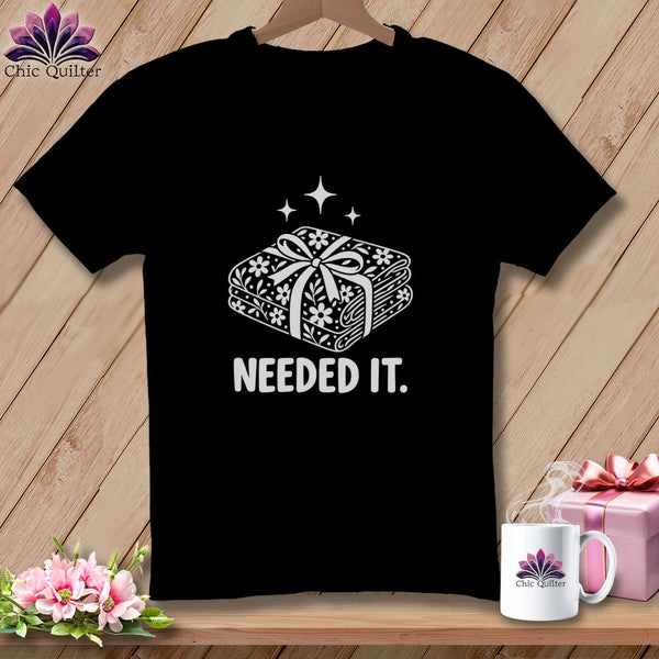 Black t-shirt with white graphic of fabric bundle and "NEEDED IT." text.