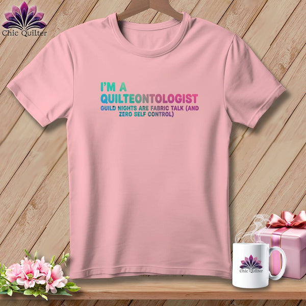 Pink t-shirt with "I'm a Quilteontologist" and humorous quilting quote.