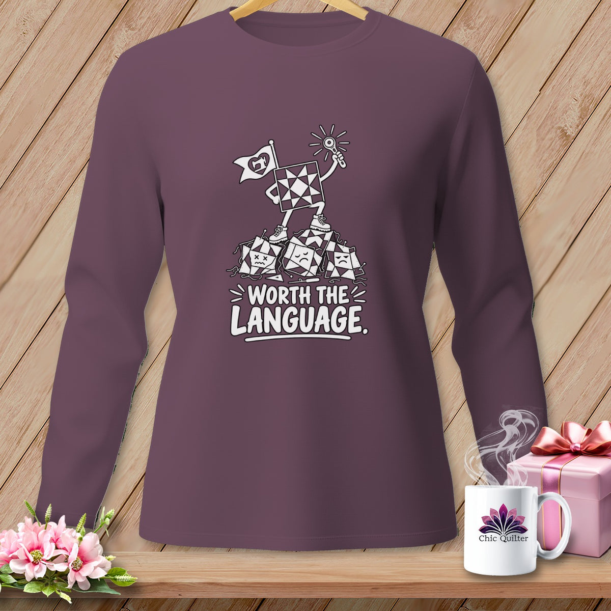 Long sleeve shirt with a quilt block character standing on defeated blocks, "Worth the Language."