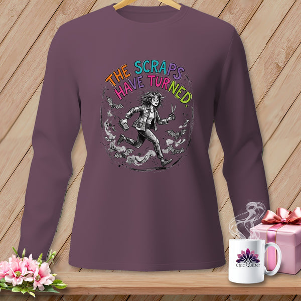 Long sleeve shirt with graphic: "The Scraps Have Turned" and a running figure with scissors.