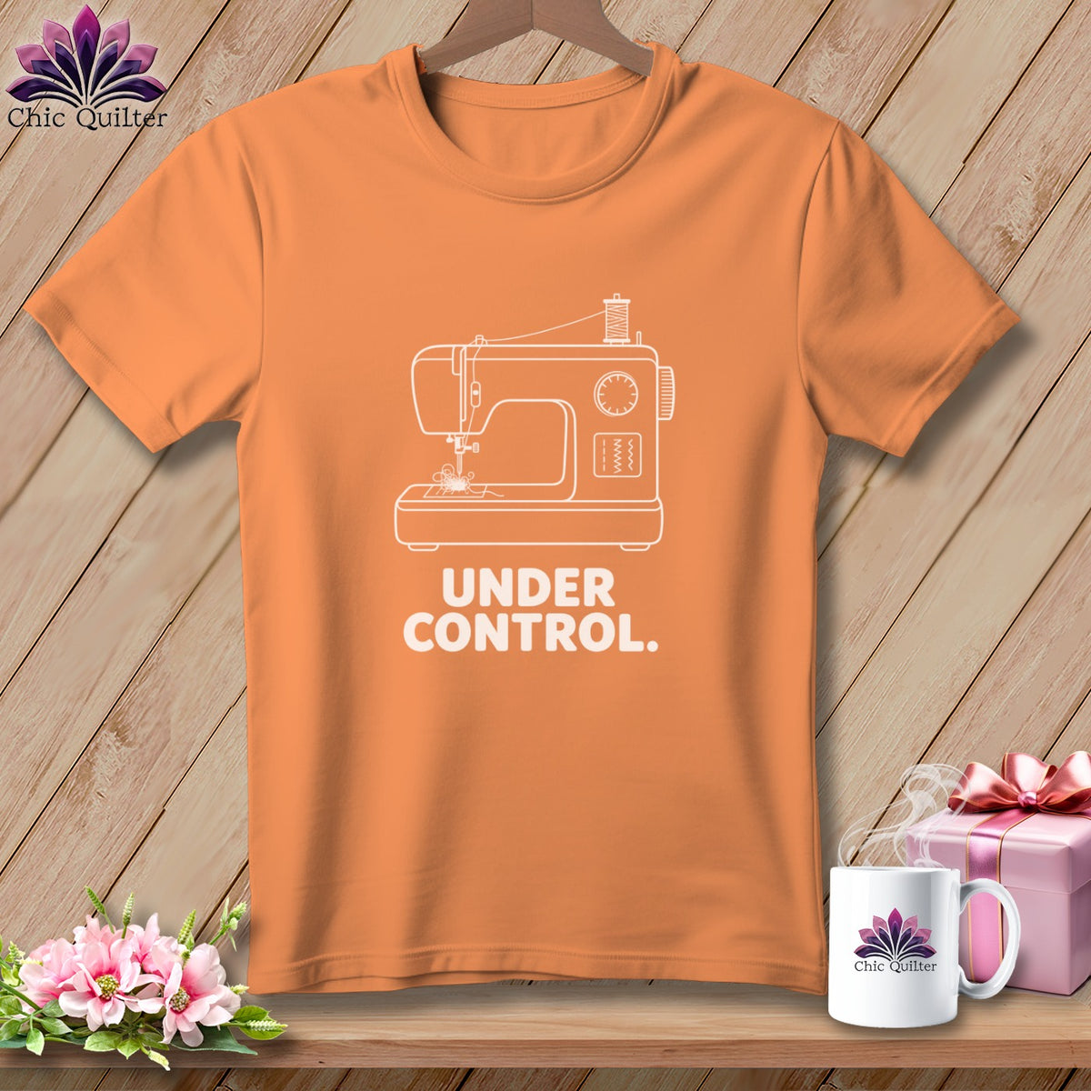 Orange t-shirt with white sewing machine graphic and text "UNDER CONTROL."