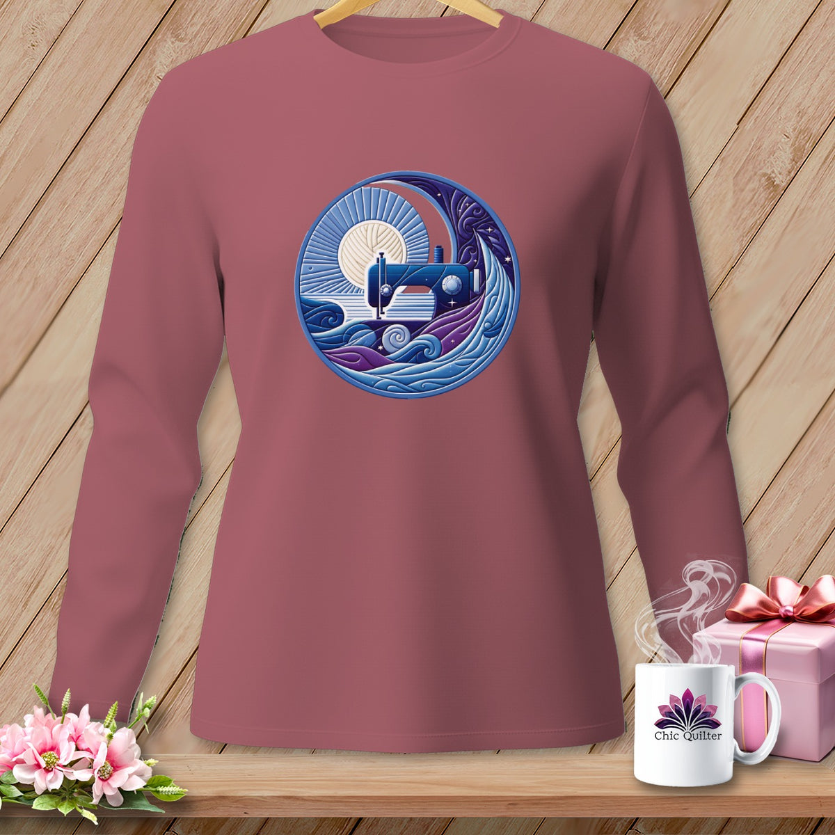 Mauve long-sleeve shirt with a circular sewing machine and yarn graphic.