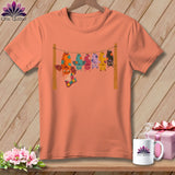 Coral t-shirt with colorful bats hanging on a clothesline with a quilt.