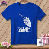 Blue t-shirt with graphic of hand holding scissors cutting fabric and text 