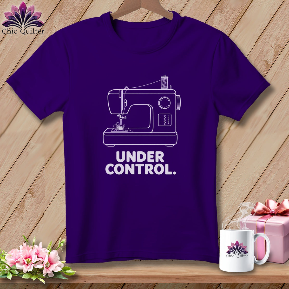 Purple t-shirt with white sewing machine graphic and text "UNDER CONTROL."