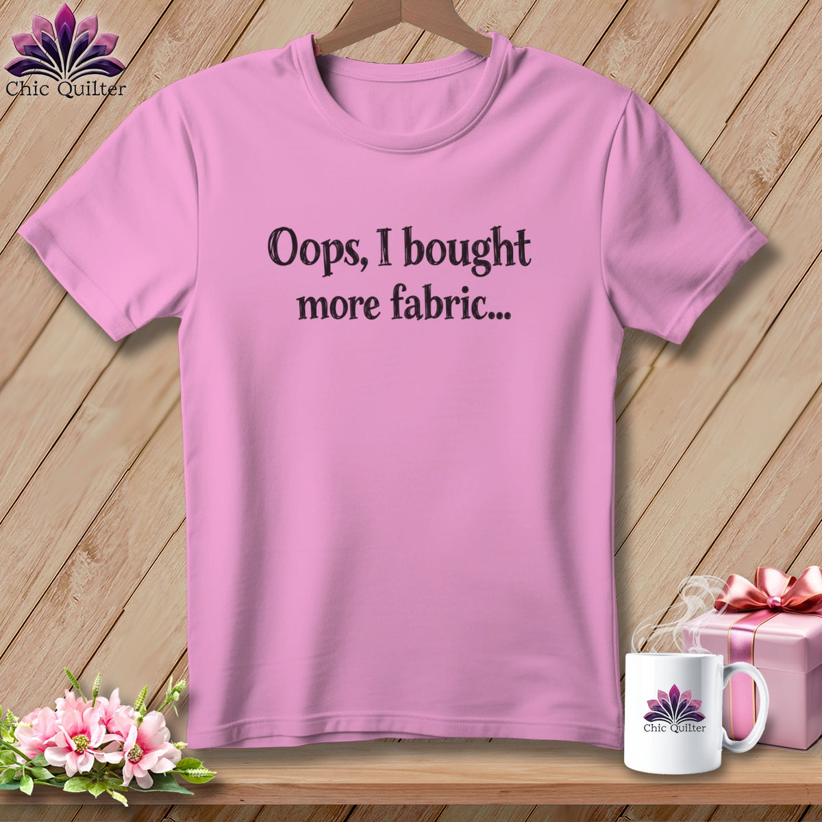 Pink t-shirt with black text "Oops, I bought more fabric..."