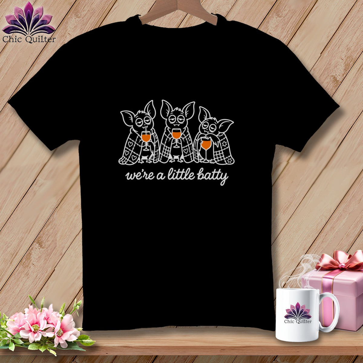 Black t-shirt with three cartoon bats holding wine glasses, text "we're a little batty".