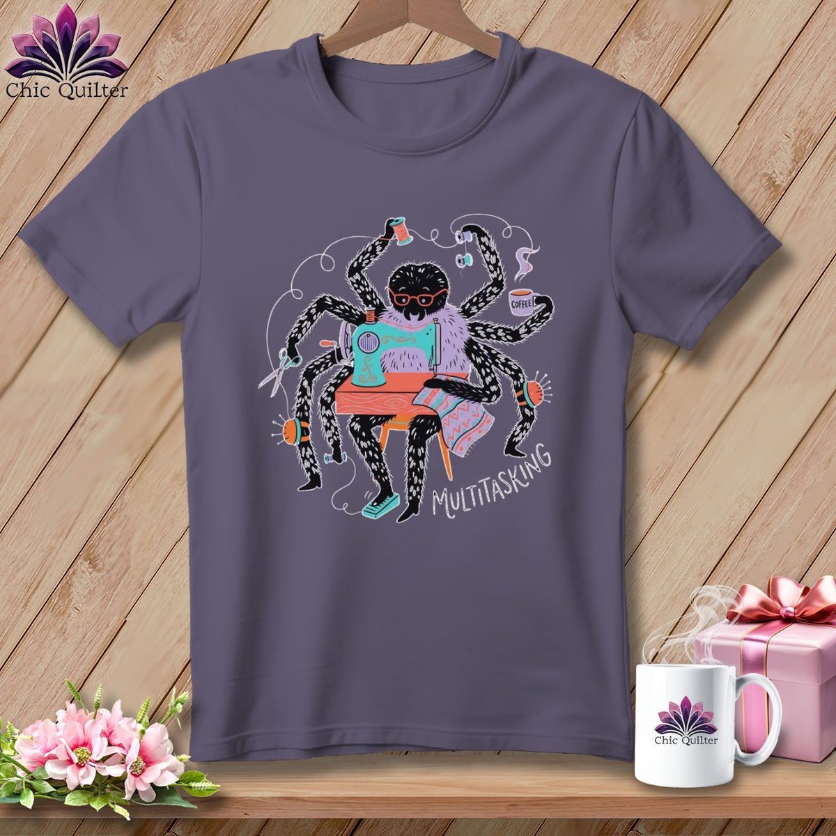 T-shirt with a spider using a sewing machine and holding coffee, reading "Multitasking."