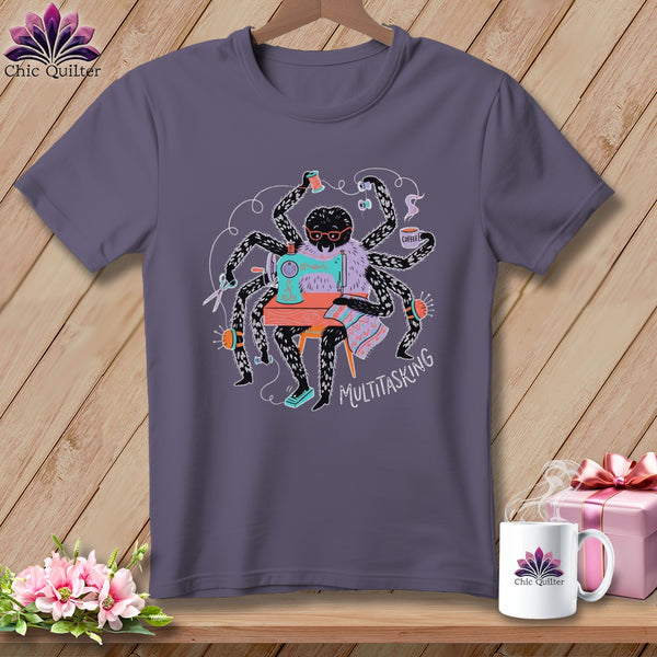 T-shirt with a spider using a sewing machine and holding coffee, reading "Multitasking."