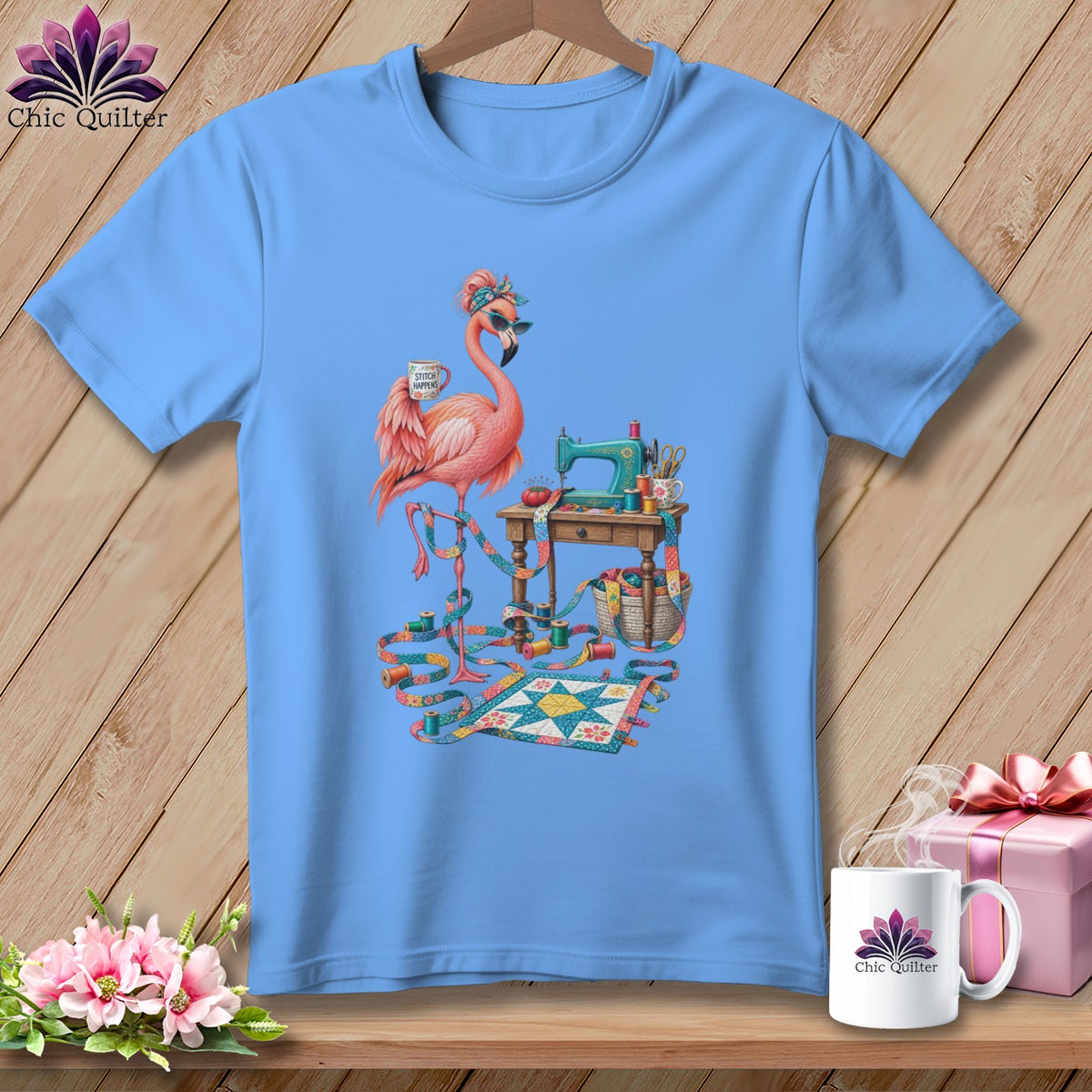 Blue t-shirt with a flamingo sewing on a miniature quilt.