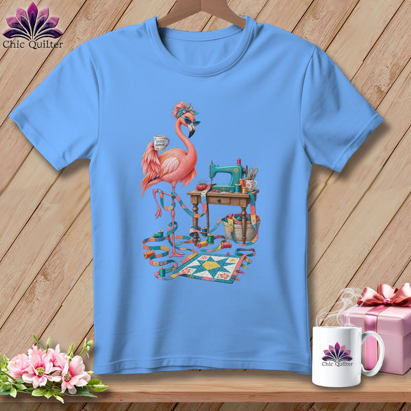 Blue t-shirt with a flamingo sewing on a miniature quilt.