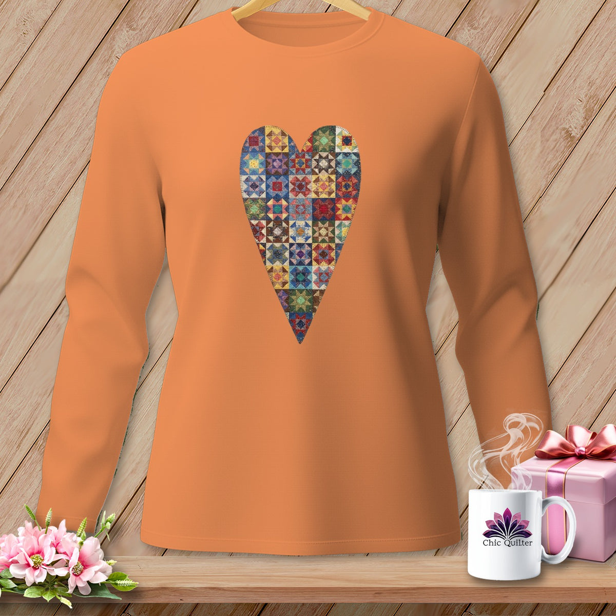 Orange long-sleeve shirt with a colorful patchwork heart graphic.